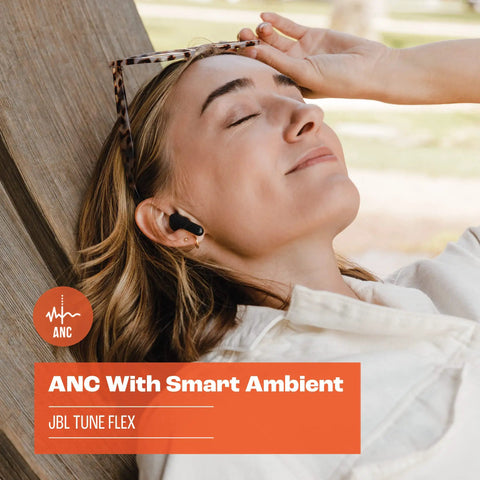 Woman enjoying music with Tune Flex True Wireless Earbuds With Pure Bass Sound From 12mm Drivers, relaxing in a park.