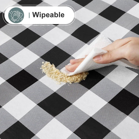 Waterproof Vinyl Rectangle Table Cloth With Soft Flannel Backing being wiped clean, buffalo check black and white design, 60x84 inches