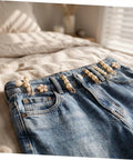 Eight Piece Pearl Waist Tightener Pin Set Elegant Alloy Dress Cincher Clips on denim jeans for gap filling and secure fit.