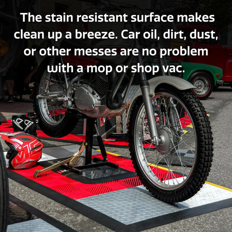 Motorcycle on interlocking garage floor tiles with red and grey pattern