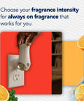 Hand inserting Coastal Sunshine Citrus PlugIns Air Freshener Starter Kit With 1 Warmer And 1 Refill into wall outlet
