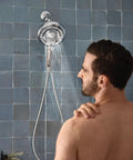 A man using Quattro Handheld Shower System With Four Modes Relieve Soothe Clarify Cleanse Magnetix Dock Chrome Finish.