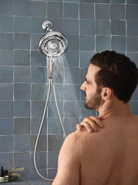 A man using Quattro Handheld Shower System With Four Modes Relieve Soothe Clarify Cleanse Magnetix Dock Chrome Finish.