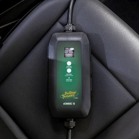 Dead Simple 16 Amp Level One Portable Ev Charger on a car seat with a digital display showing charge levels.