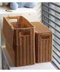 Tall Narrow Rattan Storage Bin With Lid Slick Vertical Woven Organizer For Living Room Cabinet Shelf And Pantry displayed on a white shelf.