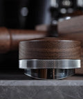 Side view of Walnut 58.35mm Espresso Distribution Tool, Adjustable Depth, Stainless Steel Leveler For 58mm Portafilters on a counter.