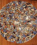Circular mosaic tabletop with 10 Pound Bundle Of Broken Mexican Talavera Tiles For Mosaic Projects And DIY Decor, colorful patterns visible.
