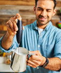 Person using Powerful Handheld Milk Frother For Coffee Lovers, Quick Foam Maker Whisk For Lattes, Cappuccinos in kitchen