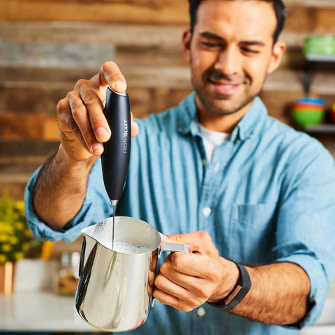 Person using Powerful Handheld Milk Frother For Coffee Lovers, Quick Foam Maker Whisk For Lattes, Cappuccinos in kitchen