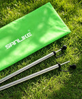 Adjustable Heavy Duty Tarp Poles Set Of 2 on grass with a green carrying bag, 90 Inch Telescoping Camping Poles For Tents, Stainless Steel