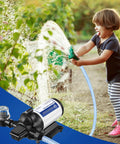Child using Self Priming 115V Water Pump 4 GPM 45 PSI Diaphragm Booster with garden hose, pump visible with fittings and filter