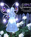 Solar Angel Garden Stake Lights 2 Pack With 7 LEDs for Cemetery Grave Decor Memorial Gift, glowing in a garden with flowers.