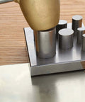 Oval Disc Cutter Set With Seven Punches And Die for Soft Metal Up To 14 Gauge, showing tool in use on wooden table