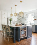 Modern Gold Moravian Star Pendant Light With Clear Glass Shade Adjustable in a kitchen setting