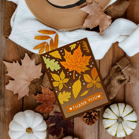 Autumn-themed card with leaf patterns and 'Thank You' message, surrounded by pumpkins and leaves.