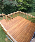 Wooden deck stained with Premium Semi Transparent Outdoor Wood Stain And Sealer In One For Decks Fences And Siding Water Based Stain With UV Protection Cedar Color Two And A Half Gallon Easy To Apply And Maintains Natural Wood Grain outdoors, surrounded by trees