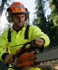 Man using chainsaw wearing Chainsaw Helmet With Face Shield And Ear Muffs For Logging And Tree Cutting ANSI Certified Forestry Hard Hat