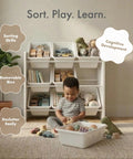 Child playing with toys near Three Tier Toy Storage Organizer With Nine Removable Bins For Kid Friendly Playroom No Mess Easy Cleanup Durable Engineered Wood Frame Sturdy Toddler Toy Organization In White