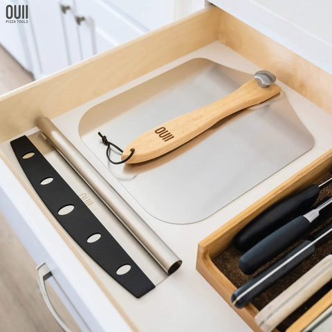 Front view of OUII aluminum pizza peel with wooden handle, 12 x 14 inches.