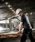 Worker using Top Shelf 18V Lithium Ion Brushless Drill Driver With Electric Brake Led Work Light and 21 Torque Settings on wood.