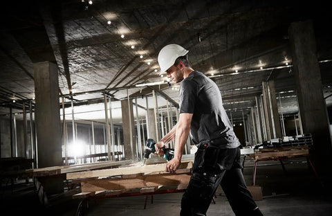 Worker using Top Shelf 18V Lithium Ion Brushless Drill Driver With Electric Brake Led Work Light and 21 Torque Settings on wood.