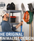 Person using Heavy Duty Garage Wall Mount Tool Hook Rack For Shovels Rakes Brooms Hoses And Cords Industrial Steel Powder Coated Design Holds Up To 50 Pounds Ultra Strong Yard And Workshop Organizer For Easy Access in garage