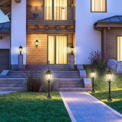 Outdoor Dusk To Dawn Post Light Lantern, 20 Inch High Bronze Lamp Post with Pier Mount illuminating a house pathway.
