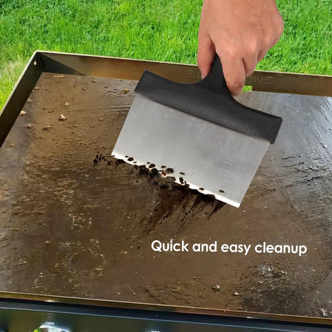 Ultimate Griddle Cleaning Kit For Flat Top Grill 18 Piece Cleaner Set with scraper on a dirty grill surface