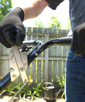 Close up of hands adjusting the handle of 50 Lb Capacity Push Broadcast Spreader For Lawns And Gardens, Model P20-500BH.