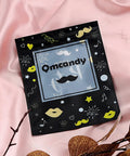 Black Qmcandy pouch with mustache and lips design on pink fabric background