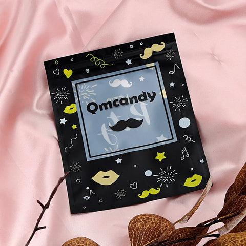Black Qmcandy pouch with mustache and lips design on pink fabric background
