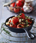 Heavy Duty Cast Iron Skillet Set With Cookbook, 6.25 Inch pan filled with roasted tomatoes and herbs on wire rack