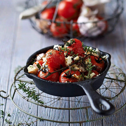 Heavy Duty Cast Iron Skillet Set With Cookbook, 6.25 Inch pan filled with roasted tomatoes and herbs on wire rack