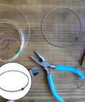 Premium Nickel Chromium Heating Element Replacement Strip For Heat Shrink Film Sealer on wooden surface with pliers and wire.
