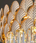 Close-up of European Style Indoor Wall Sconce Featuring Cut Crystal Accents And Brushed Metal Frame highlighting leaf design.