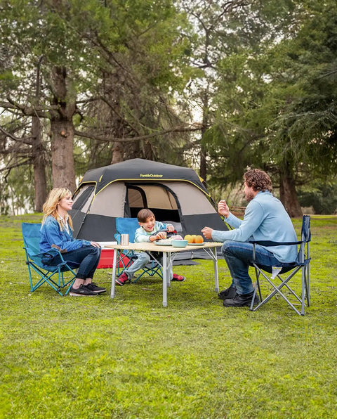 Family enjoying outdoor meal near Zeta C6 Pro Six Person Instant Cabin Tent with 60 Second Setup, khaki, in forest setting.
