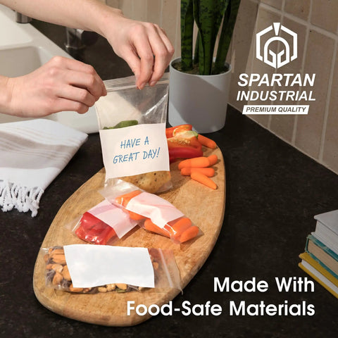 Top Shelf Nine By Twelve Inch Clear Plastic Ziplock Bags Quick Snap Zip Seal And Writable White Label Blocks Five Hundred Count on a kitchen counter.