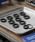 Solid Impact Wrench Retaining Rings With O-Rings 1/2 Inch 10 Sets on a tray ready for installation, made of iron for pneumatic or electric wrenches.