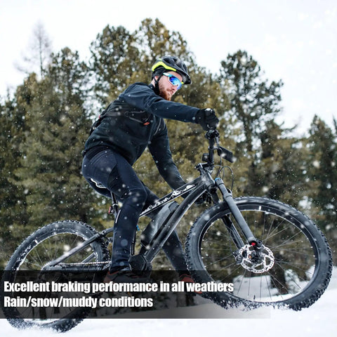 Cyclist riding in snow using Four Pairs Bike Brake Pads Kit With Pins And Springs For Mountain Bikes, high performance stopping