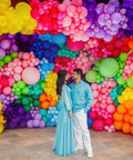 Awesome Assorted Rainbow 5 Inch Latex Balloons 100 Pack For Birthday Bash And Wedding Decor displayed as colorful backdrop at a celebration.