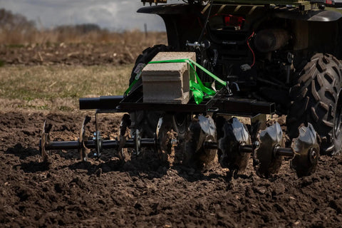 ATV pulling disc plow harrow with weight tray, 54-inch width, eight notched discs. Product: Disc Plow Harrow With Weight Tray For ATV UTV And Garden Tractors For Heavy Duty Soil Prep Weed Control And Crop Residue Clearance Built Tough For Real Dirt Work That Feels Like A Beast And Cuts Through Tough Weeds.