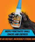 Ultimate Clear Super Glue 15 Grams Heavy Duty Fast Set Bond For Quick Fixes And Home Repairs With Anti Clog Cap Cyanoacrylate Adhesive For All Purpose Use bottle held by a hairy hand against an orange background.