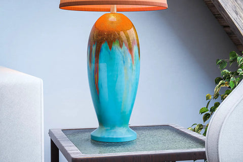 Elaine Table Lamp With Antique Mercury Glass And Brushed Steel Finish on a side table, vibrant blue glass body, living room decor
