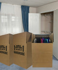 Space Saver Wardrobe Moving Boxes With Hanger Pack Of 3 Shorty Wardrobe Boxes 20x20x34 Inches set in front of a closet.