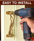Installing peacock decorative brass door handles on interior door with drill.