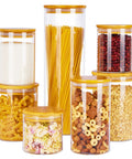 Airtight Glass Storage Jars Set Of 7 With Bamboo Lids For Pasta Cookies Nuts Coffee Beans Cereal Flour Pantry Organization BPA Free Clear Glass Canisters filled with pasta, cereal, and snacks.