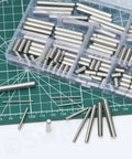 Boss Level 304 Stainless Steel Dowel Pin Assortment Featuring 180 Pieces Across Nine Sizes on green mat, showing varying lengths.