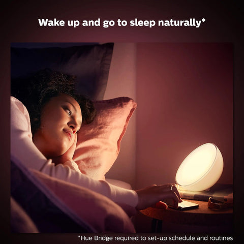 Person using Smart Portable Dimmable Table Lamp For Indoor And Outdoor Use With Color Changing LED Ambiance IP54 on bedside table.