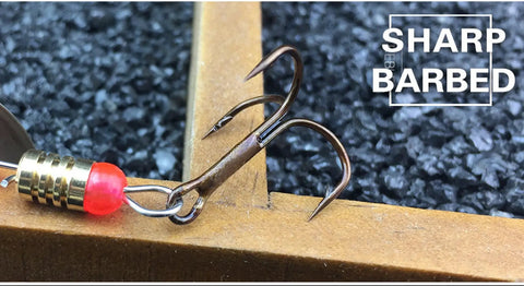 Close-up of treble hook from 12 Piece Spinnerbait Fishing Lure Kit For Bass, Trout, Salmon, Walleye And More, showing sharp barbs.