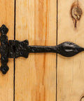Black Wrought Iron Door Strap Hinges, 6-Inch Long Antique Colonial Spear Tip, mounted on wooden surface